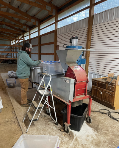 Steve Pence uses the new seed cleaning equipment to process batches of seed. Photo by Kevin Thusius.