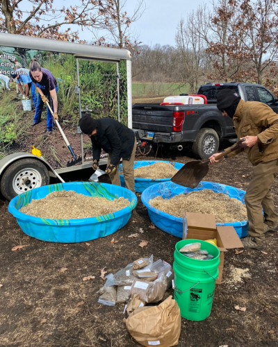 Volunteers mix native seed prior to spreading it at SwampLovers Preserve. Photo by IATA Staff.